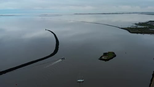 Tranquil Bay with Boat and Scenic Breakwater