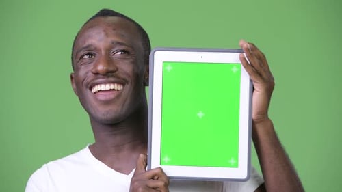 Smiling Man Holding Tablet with Green Screen