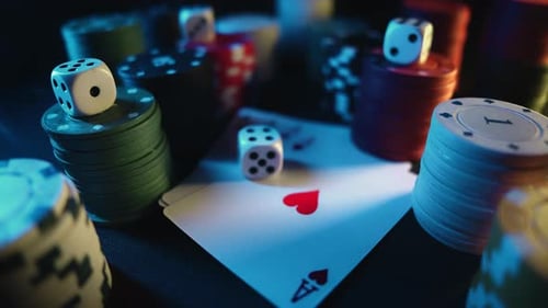 Casino Chips with Dice and Playing Cards on a Dark Table