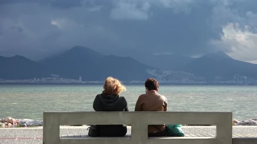 Old Women's Sitting By Beach