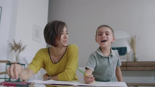 Mother and Child Drawing Together at Home