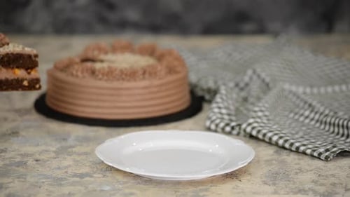 Slice of Chocolate Cake Being Served on Plate