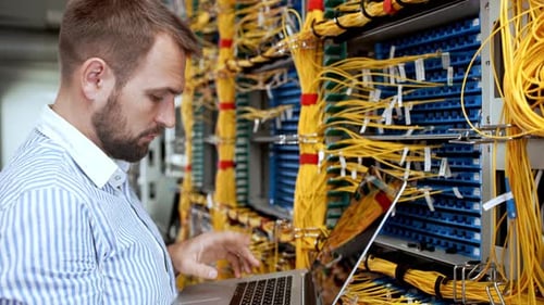 IT Technician Working on Servers with Laptop