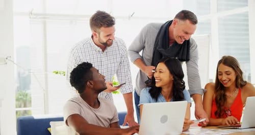 Team of executives interacting with each other while working in the office