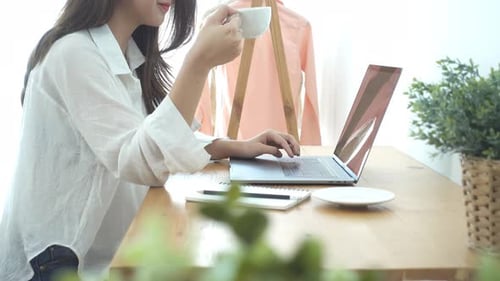 Young Woman Working on Laptop at Home