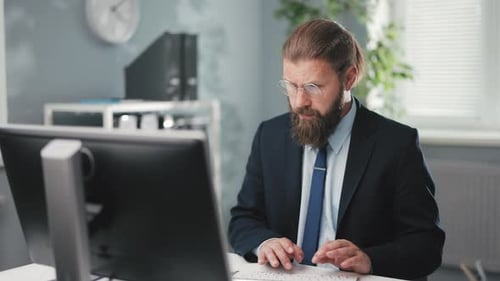 Man Working at Computer in Modern Office