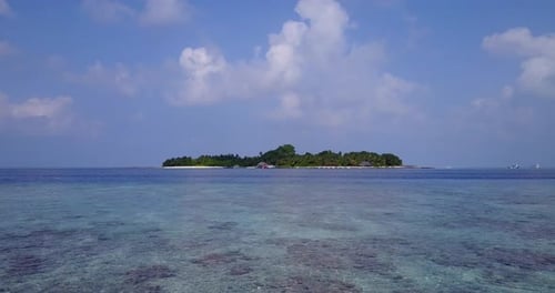 Daytime fly over tourism shot of a paradise sunny white sand beach and blue ocean background
