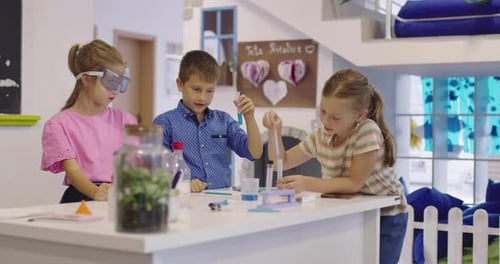 Elementary School Science Classroom Enthusiastic Teacher Explains Chemistry to Diverse Group of