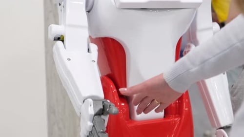 Woman Touches Hand of Humanoid Robot