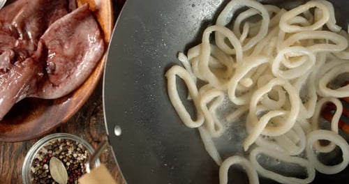 Squid Rings Boiling in Pan with Spices