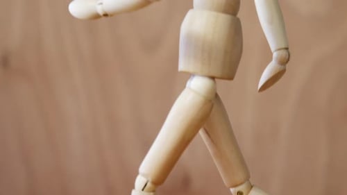 Wooden Mannequin Standing on Wood Surface