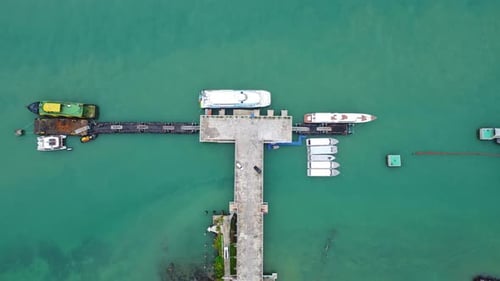 Aerial view from drone of commercial ship and cruise ship parked in the marina.