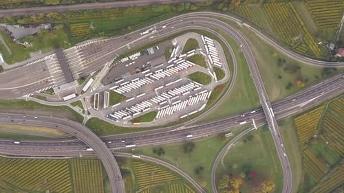 Top down aerial view of highway interstate road with fast moving traffic and parking lot with