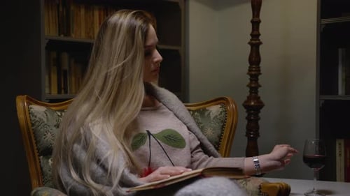 Woman Reading Book and Drinking Wine at Home