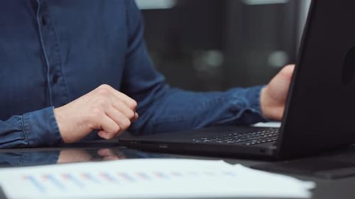 Hands of Businessman Typing on Laptop in Office