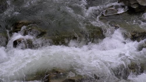 Wild Mountain River Flowing with Stone Boulders and Stone Rapids. Slow Motion