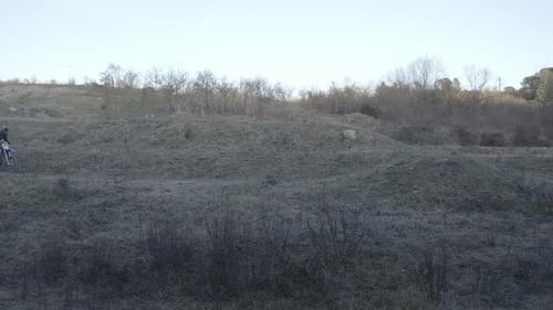 Dirt Bike Rider Jumping on Rural Trail