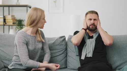 Frustrated Couple Arguing on Couch at Home