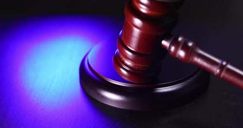 Wooden Gavel on Dark Background with Red Light