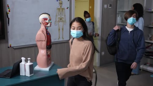 Students Enter Brightly Lit Biology Classroom With Masks