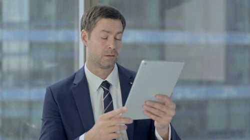 Man using Tablet for Video Conference in Office