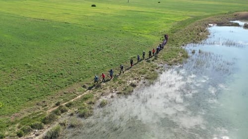 Group Of People Trekking By The Lake On Aerial View 5