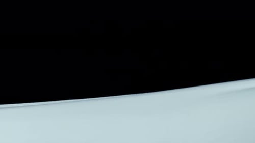 Light Blue Cloth Flowing Against Black Background