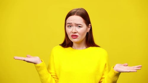 Woman Shrugs with a Confused Expression on Yellow Background