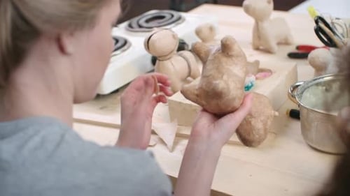 People Making Clay Figurines in Art Studio