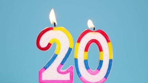 Anniversary Video Banner with Burning Colorful Number Two Candle on Blue Background