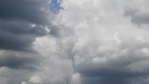 Time lapse with white clouds forming on sunny blue sky