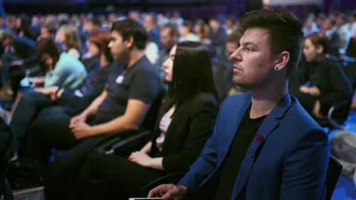 Audience Attends Corporate Conference Presentation