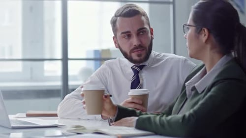 Colleagues Talking over Coffee in Office
