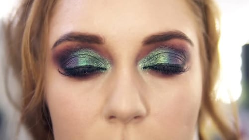 Fabulous Bright Haired Woman with Beautiful Green Eyes Makeup Opens Her Eyes
