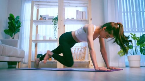 Woman Performing Mountain Climber Exercise on Yoga Mat