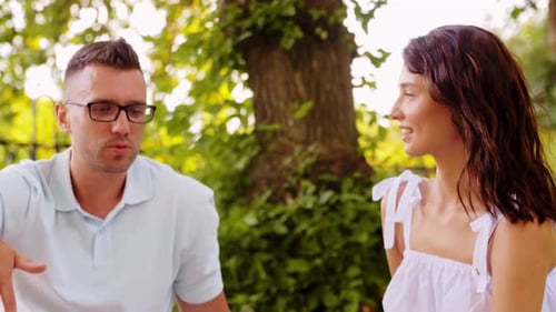 Happy Couple Talking at Summer Park