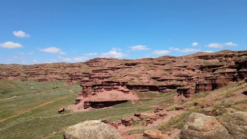 Aerial View of Layered Rock Formations and Desert Landscape