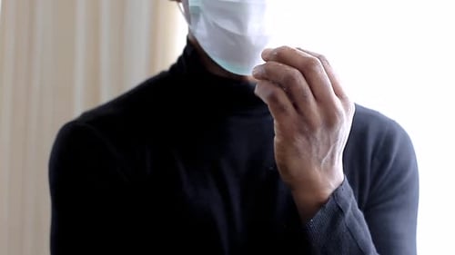 coronavirus man with spray fighting the disease on grey background stock video stock footage