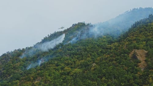 Helicopter Drops Water on Forest Fire