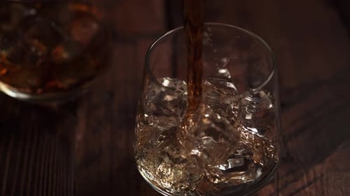Whiskey Pouring Into Glass with Ice