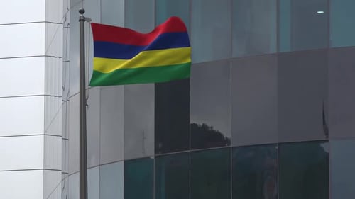 Realistic Mauritius National Flag Waving by Modern Office Building