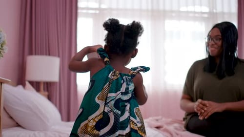 Girl Gives Birthday Gift to Smiling Woman