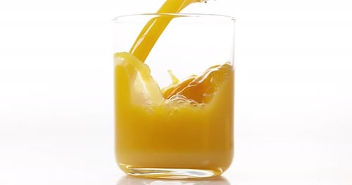 Orange Juice being poured into Glass against White Background, Slow Motion 4K