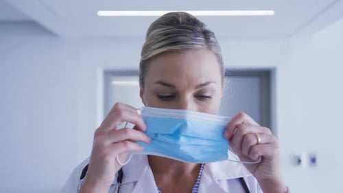 Healthcare Worker Prepares to Put on Surgical Mask