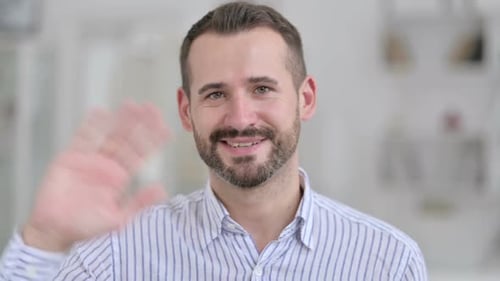 Bearded Man Waving Hello in Studio