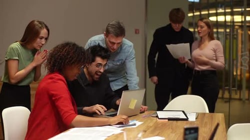 Happy Team Celebrating Success in Modern Office