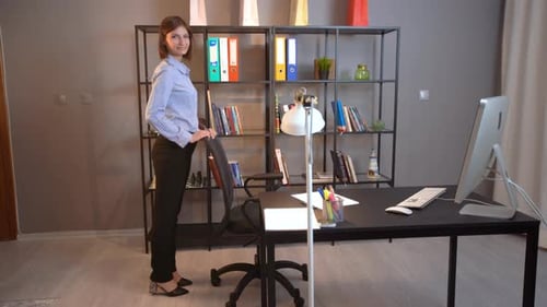 Young Adult in Office Environment Giving Thumbs Up