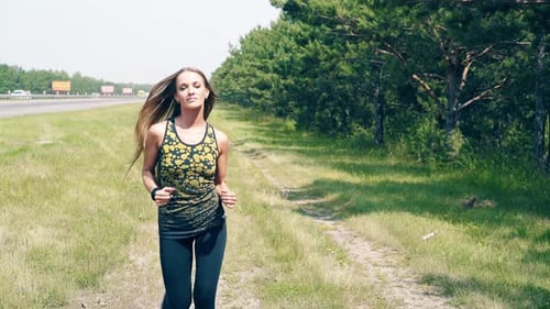 CU Portrait Young Girl Goes in for Sports in the Morning Runs Along a Pine Forest and Trails Wraps