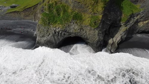 Basalt columns and a cave at Reynisfjara black sand beach in Iceland