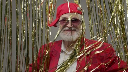 Stylish Senior Adult Posing in Front of Gold Tinsel